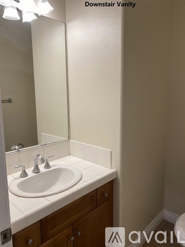 A bathroom with a sink and mirror.