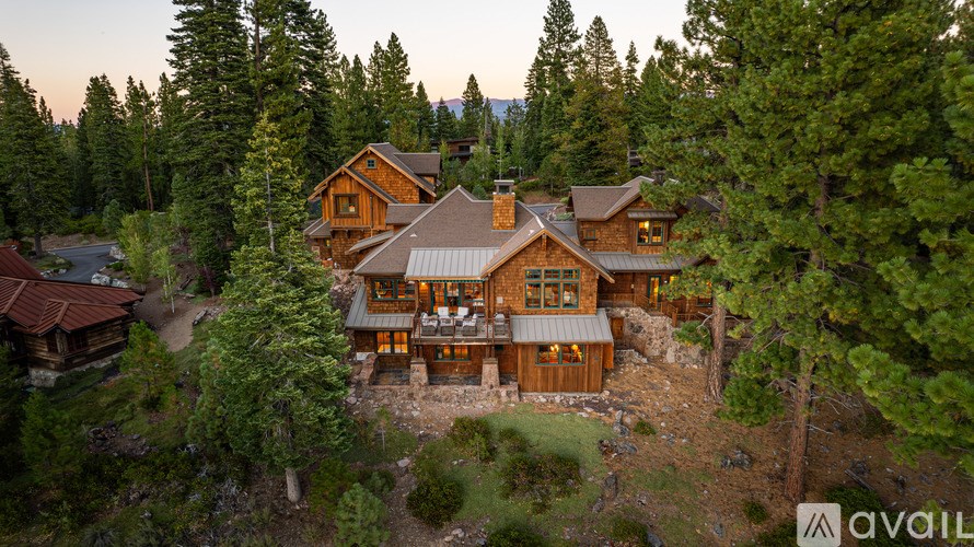 A large wooden house surrounded by trees.