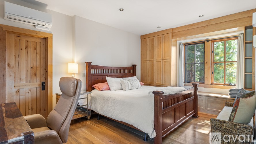A bedroom with a large bed and a window.