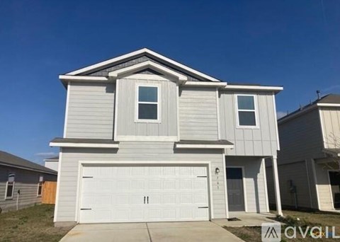 A two-story house with a garage is available for sale.