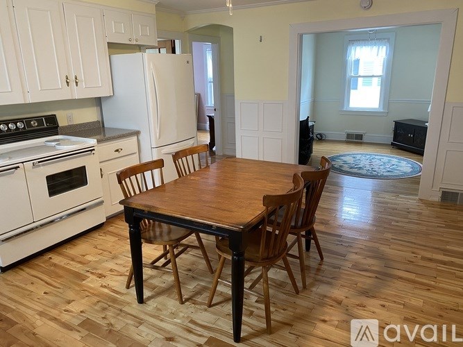 A kitchen with a table and chairs in the middle of the room.