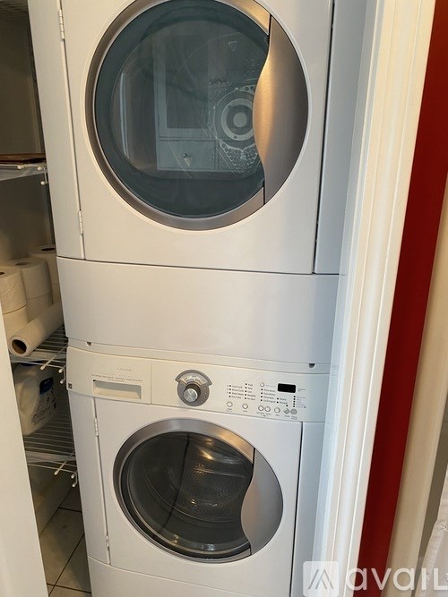 A stack of white front loading washing machines.