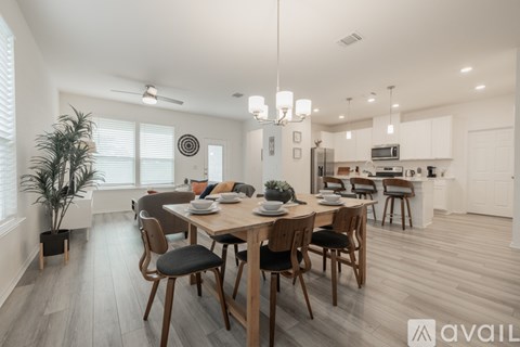A modern dining room with a wooden table and chairs.