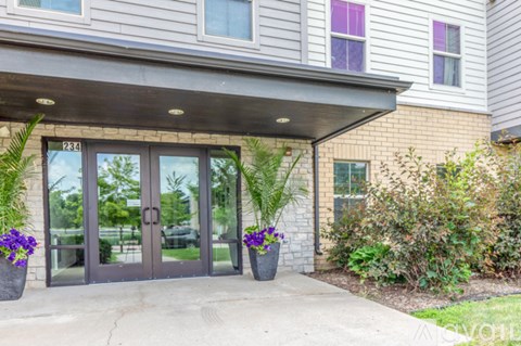 The front of a building with a glass door and windows.