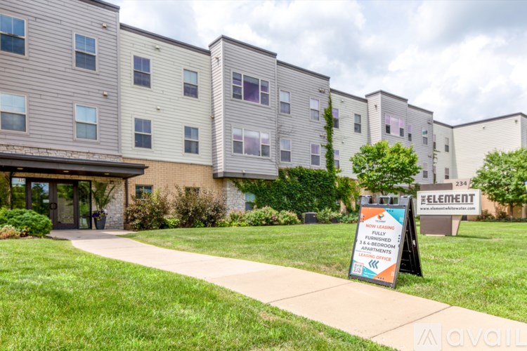 Apartment complex with a sign for a leasing event.