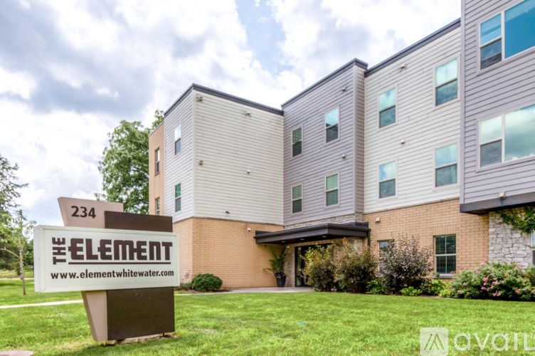 The front of apartment building called The Element with a sign in front.
