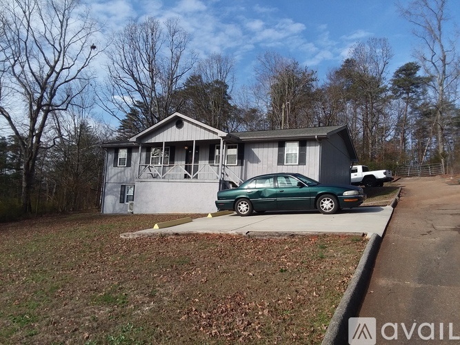 A house with a car parked in front of it.