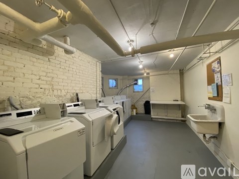 A laundry room with washers and dryers.