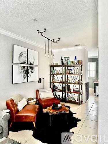 A living room with a brown leather chair and a black coffee table.