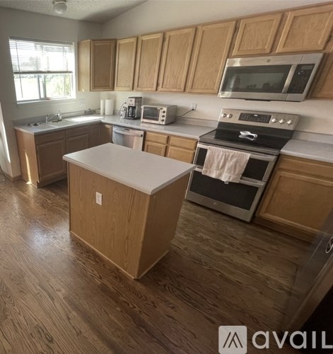 A kitchen with wooden cabinets and a white island.