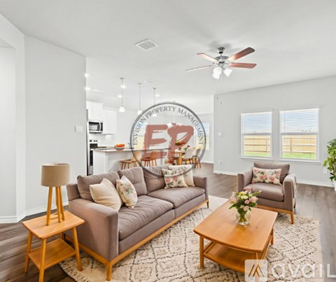 A living room with a brown couch and a wooden coffee table.