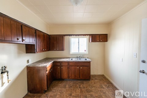 A kitchen with brown cabinets and a brown counter top.