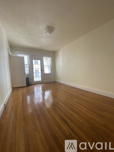 A room with wooden floors and a window.