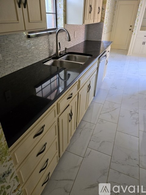 A kitchen with a sink and cabinets.