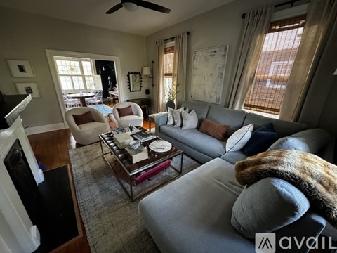 A living room with a grey couch and a coffee table.