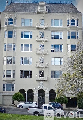 A large white building with a fire escape on the side.