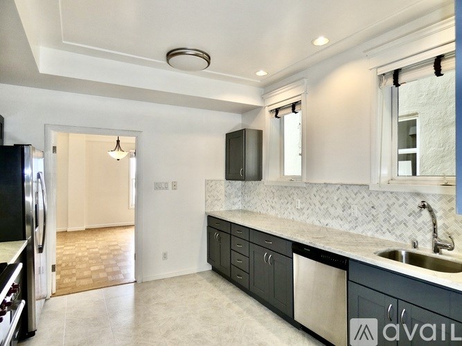 A tennis court surrounded by trees and bushes.