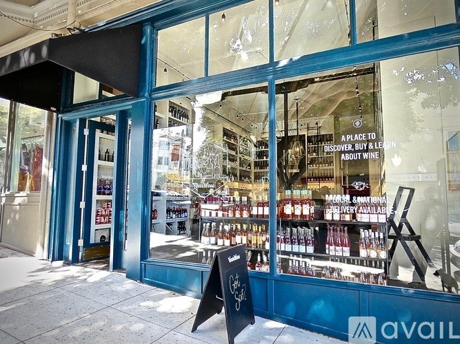 A storefront with a sign that says "A place to buy, buy & learn about wine".