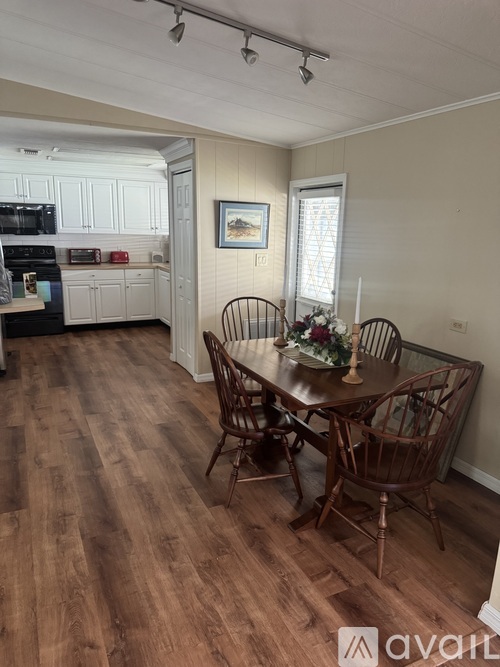 A kitchen with a table and chairs in the middle of the room.