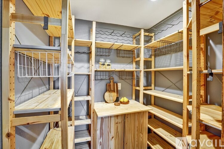 A room with wooden bunk beds and a table with a cutting board and knife on it.