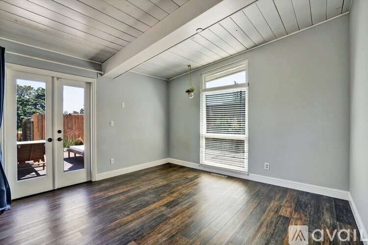 A room with wooden floors and a slanted ceiling.