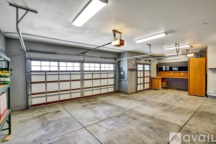 A large, empty garage with a concrete floor and a high ceiling.