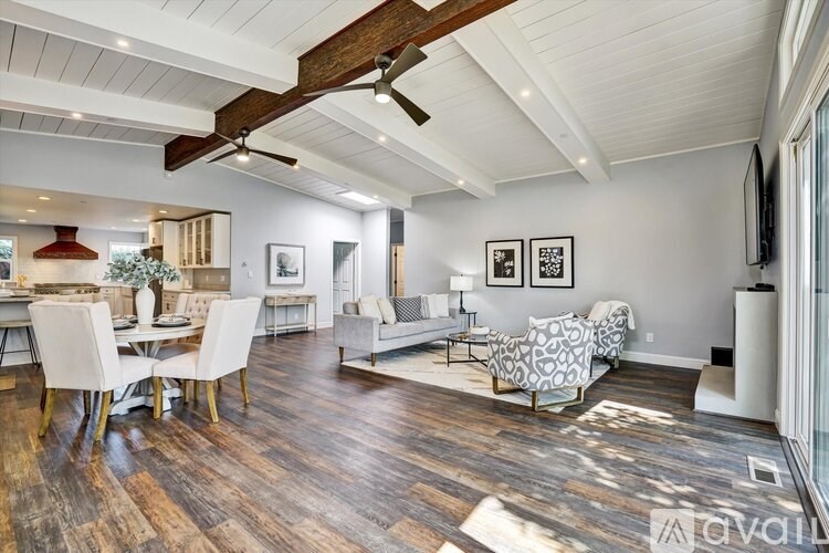 A living room with a dining table and chairs.