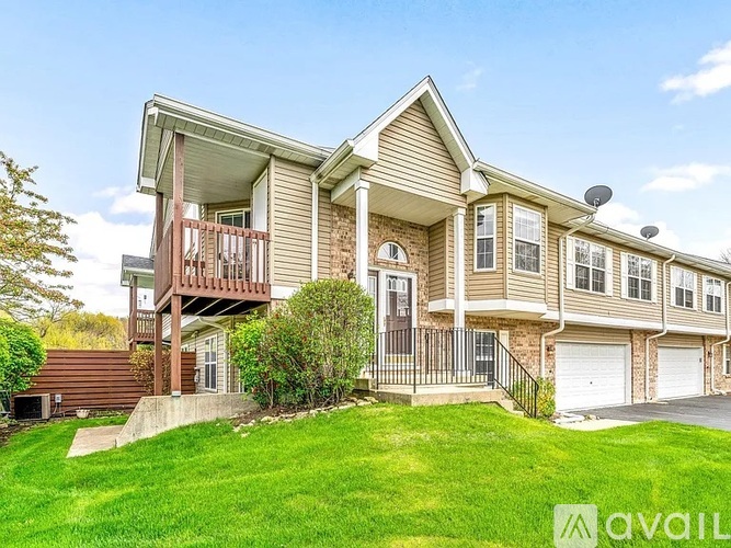 A two-story house with a balcony on the upper floor.