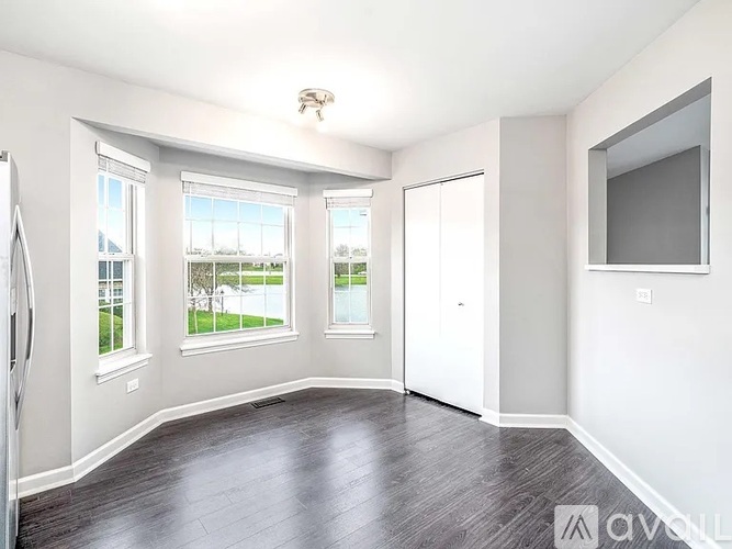 A spacious room with a television, a window, and a door.