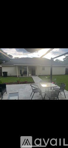 A patio with a table and chairs is shown in the image.