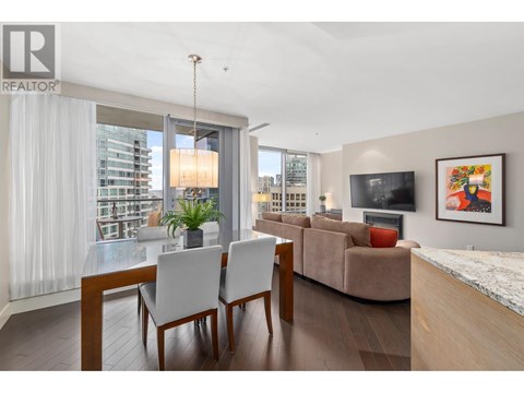 A modern living room with a dining table and chairs.