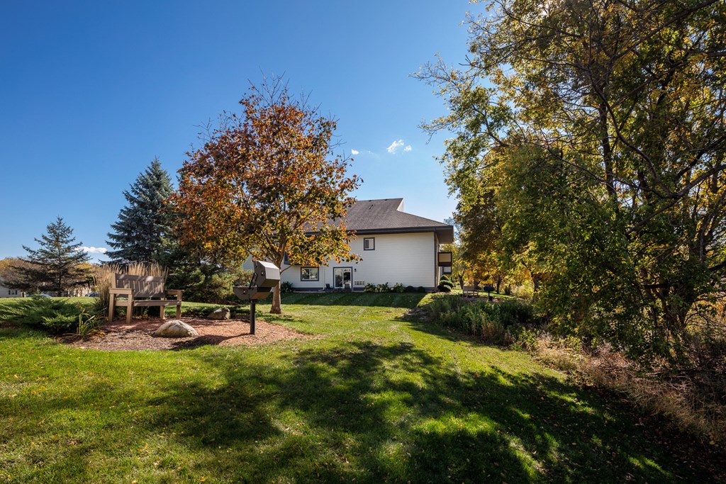 a backyard with a picnic table and a house in the background
