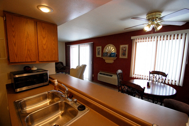 a kitchen and dining room with a sink and a table