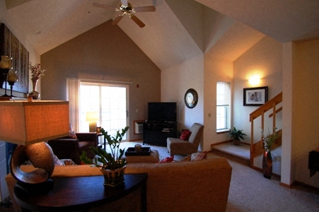 a living room with a couch and a ceiling fan