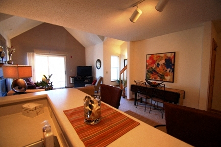 a view of a living room and a dining room from the kitchen