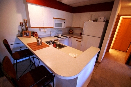 a kitchen with a counter top and a refrigerator