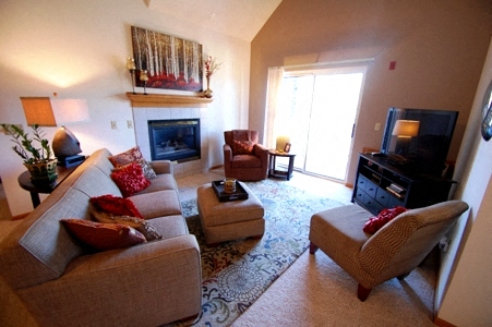 a living room with a couch and chairs and a fireplace