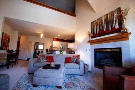 a living room with a couch and a fireplace
