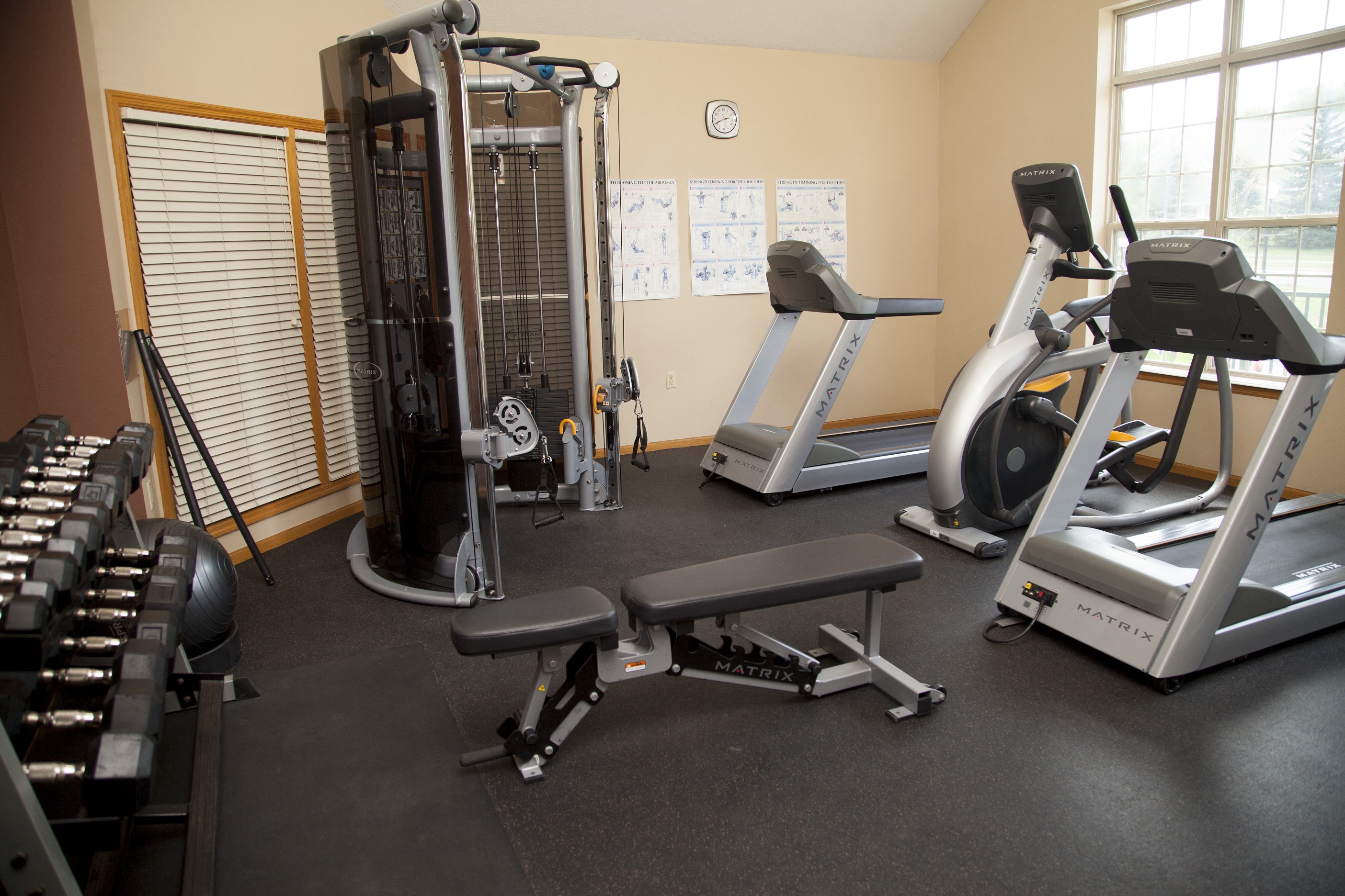 a gym with cardio machines and other exercise equipment