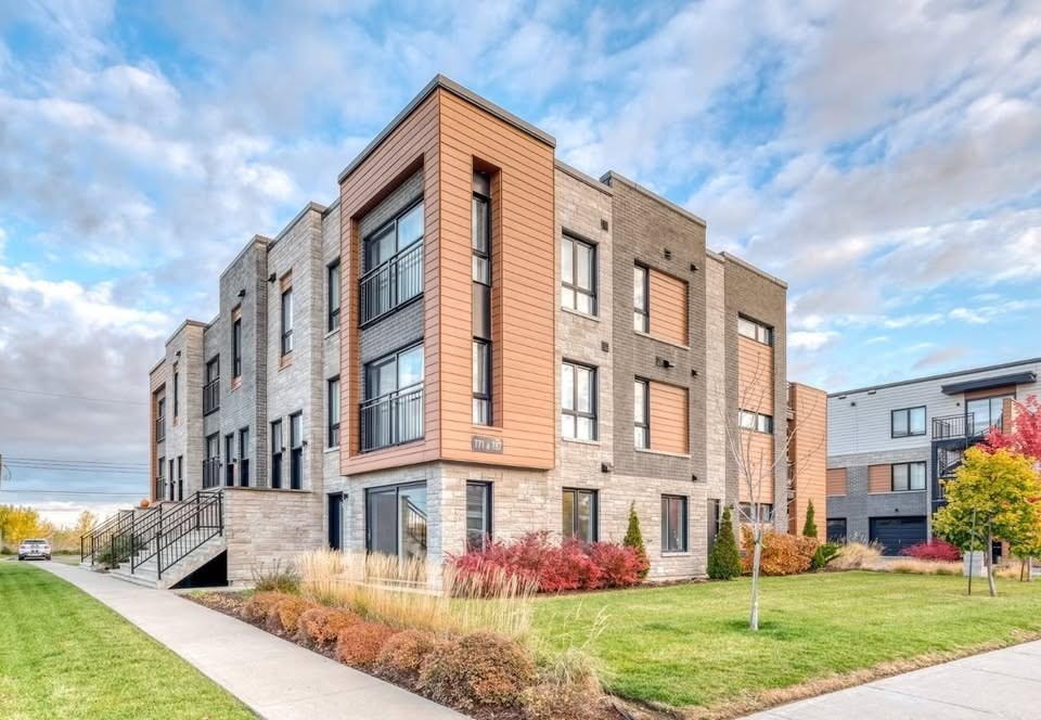 A modern apartment building with a mix of brick and panel exterior.