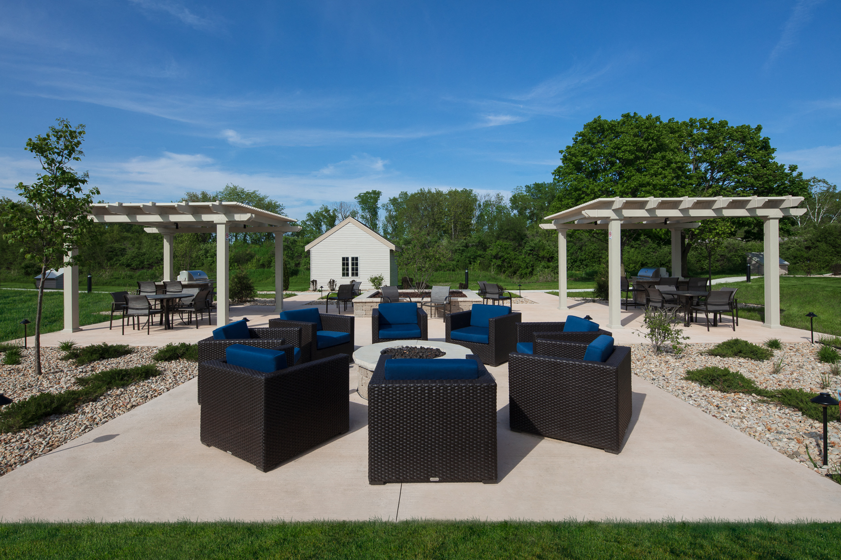 an outdoor patio with chairs and tables and a pavilion