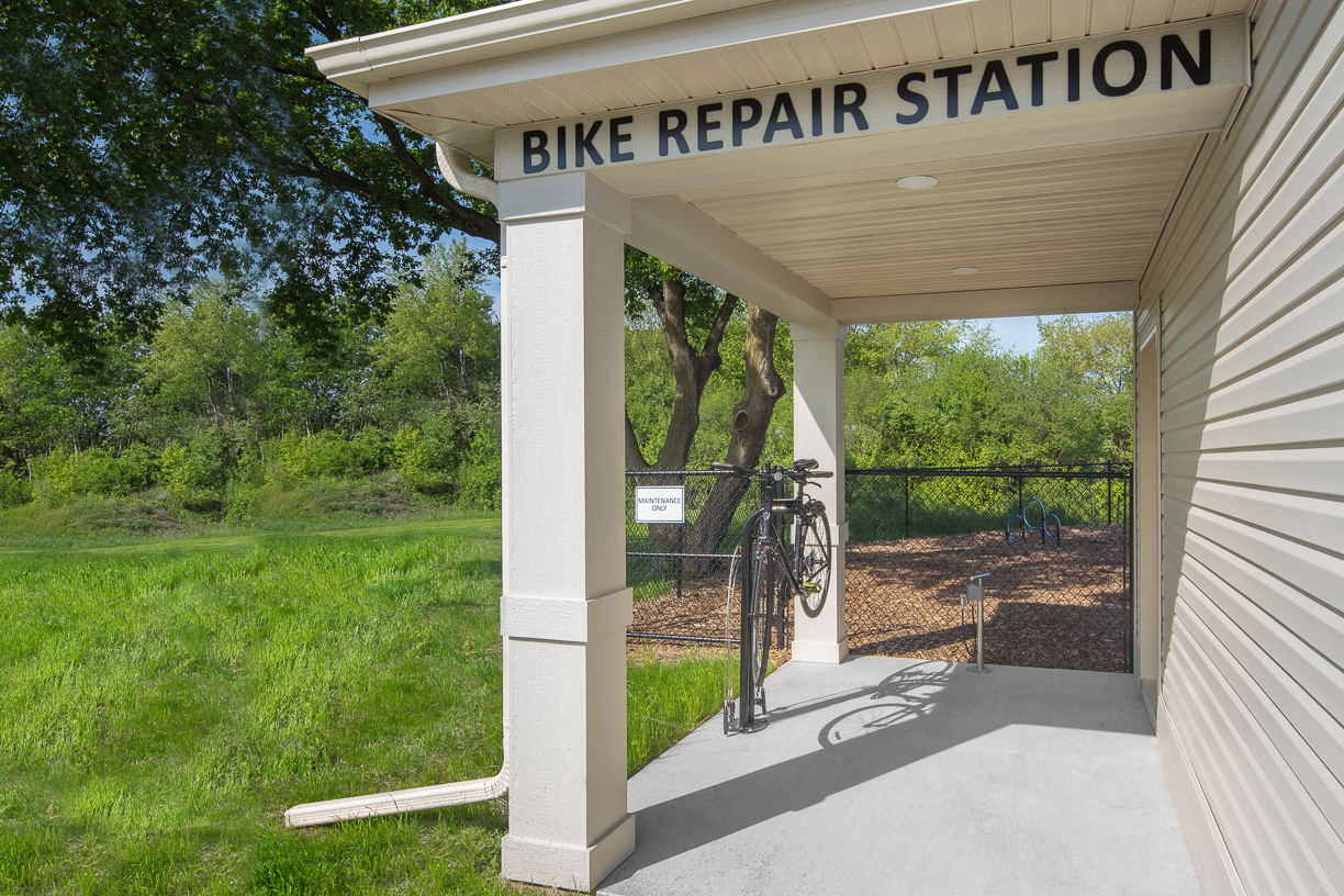 a bike repair station on the side of a building with a bike on a rack