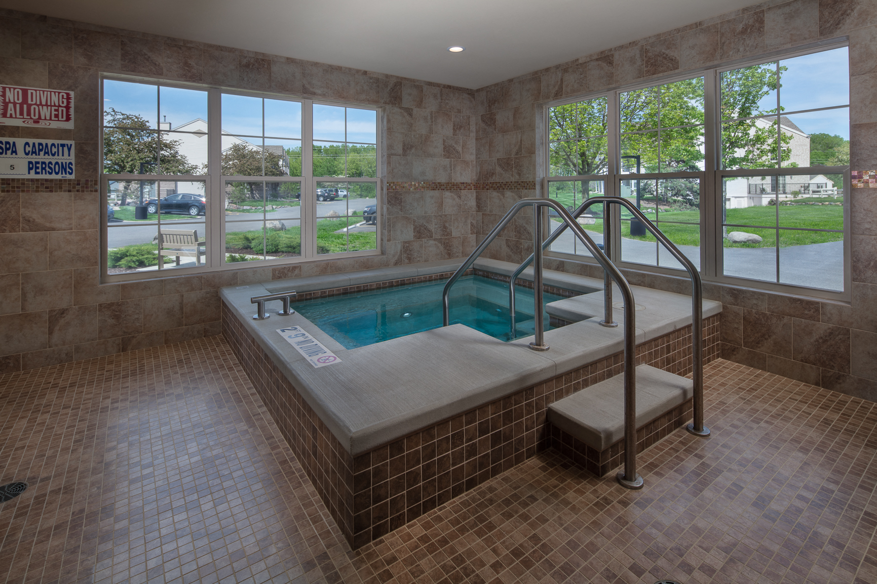 a jacuzzi tub in the corner of a spa room with windows