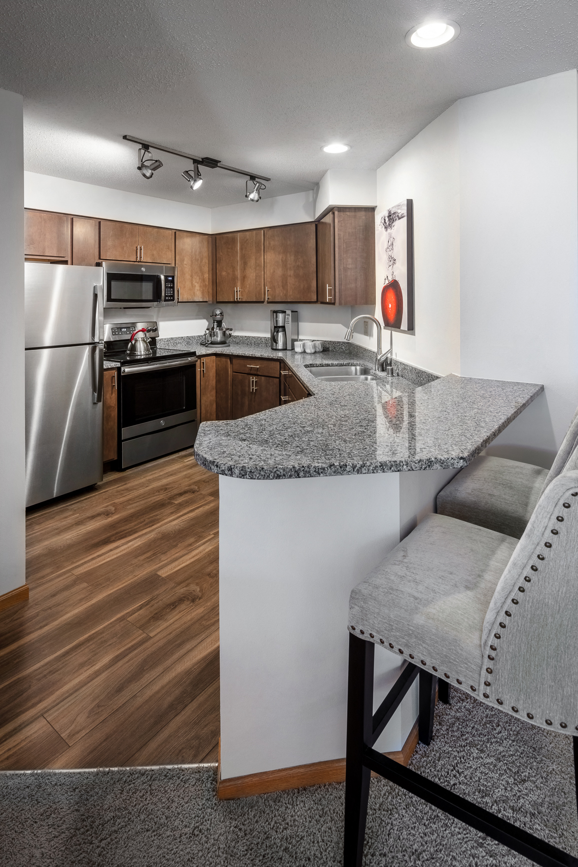 redesigned kitchen with granite countertops and stainless steel appliances at the preserve at great neck