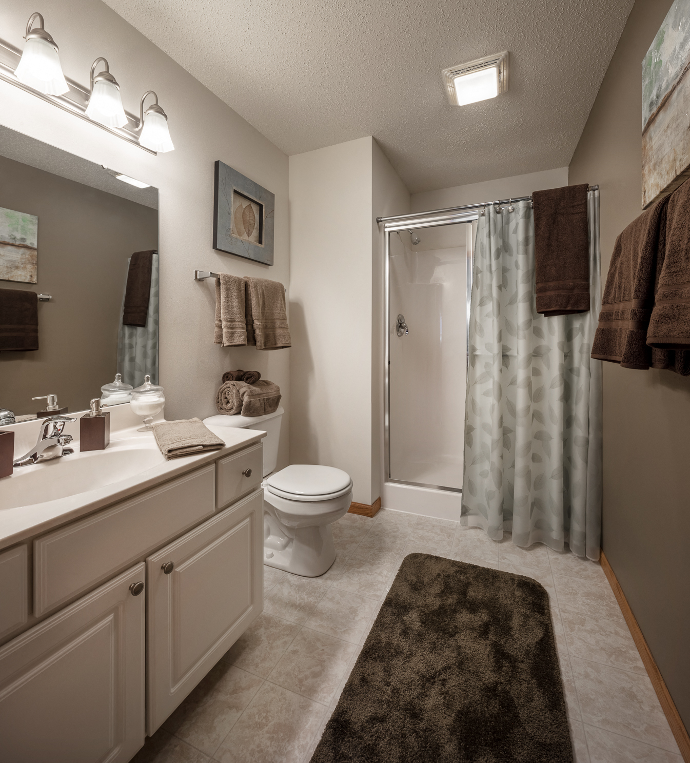 a bathroom with a shower and a sink and a toilet