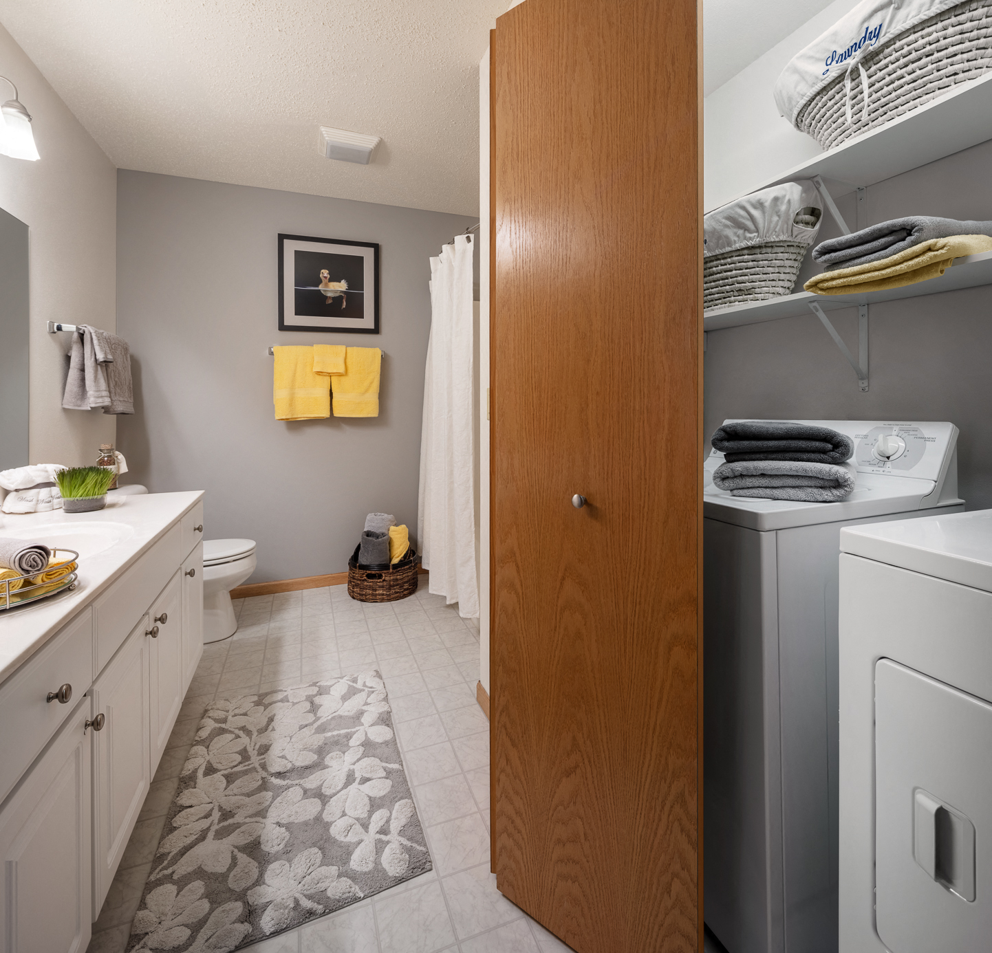 a small laundry room with a washer and dryer in it and a toilet