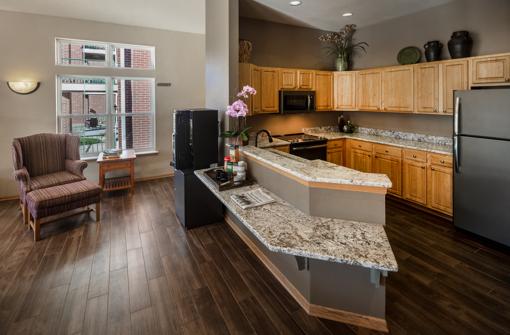 a kitchen with granite counter tops and wooden cabinets