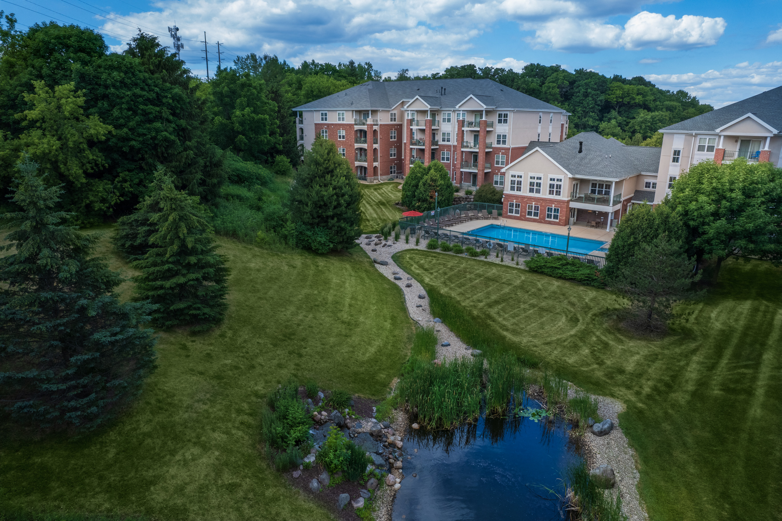 a aerial view of a yard with a swimming pool and buildings