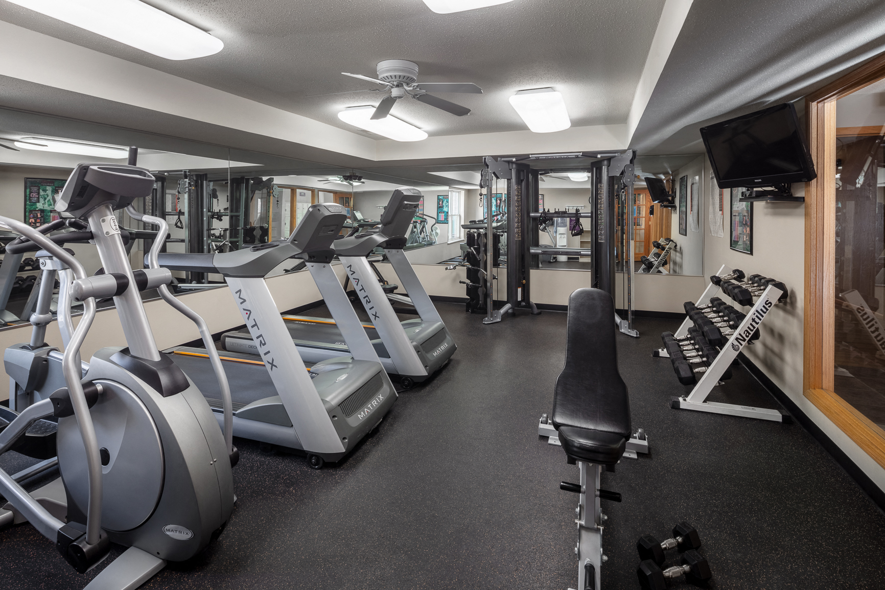 a gym with treadmills and other exercise equipment
