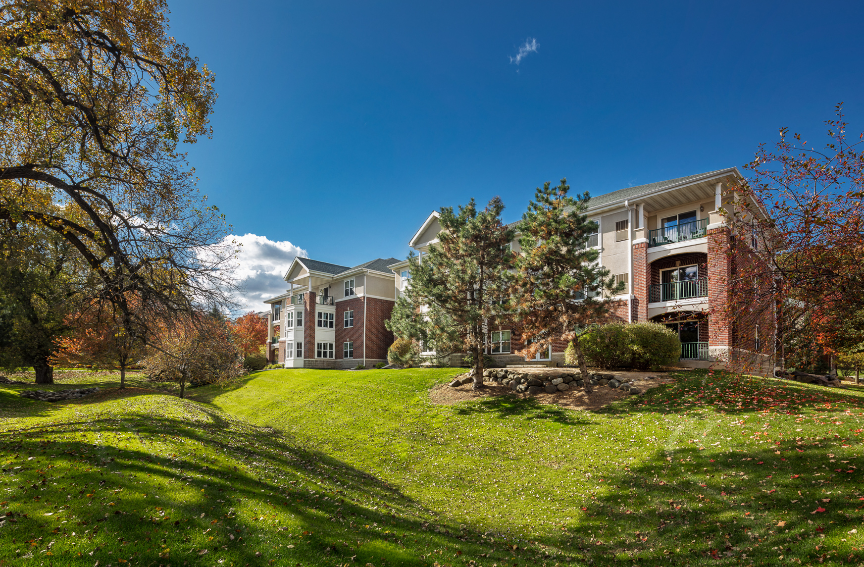 exterior view of residence hall on a sunny day with green grass and trees